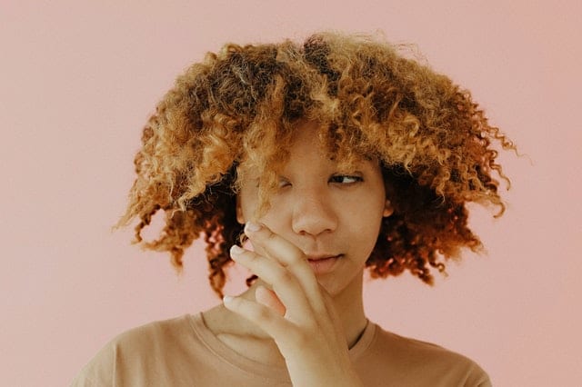 woman tugging curly hair